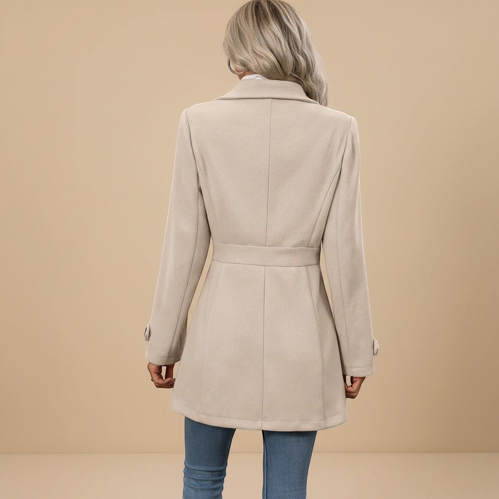 Yemelia beige tailored mid-length coat with waist belt and button front closure.