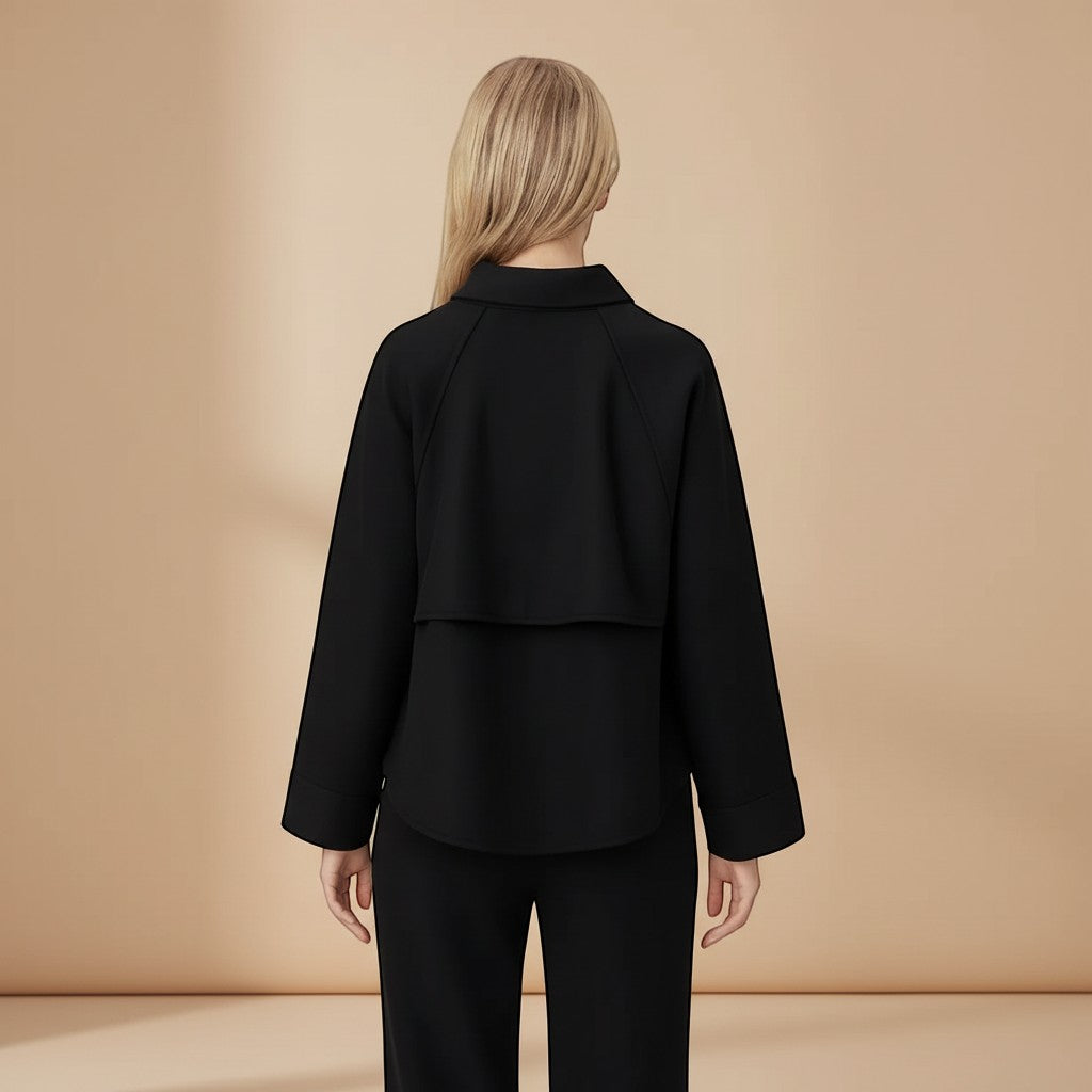 Yemelia black minimal zip front jacket with relaxed fit, classic collar, and structured fabric.