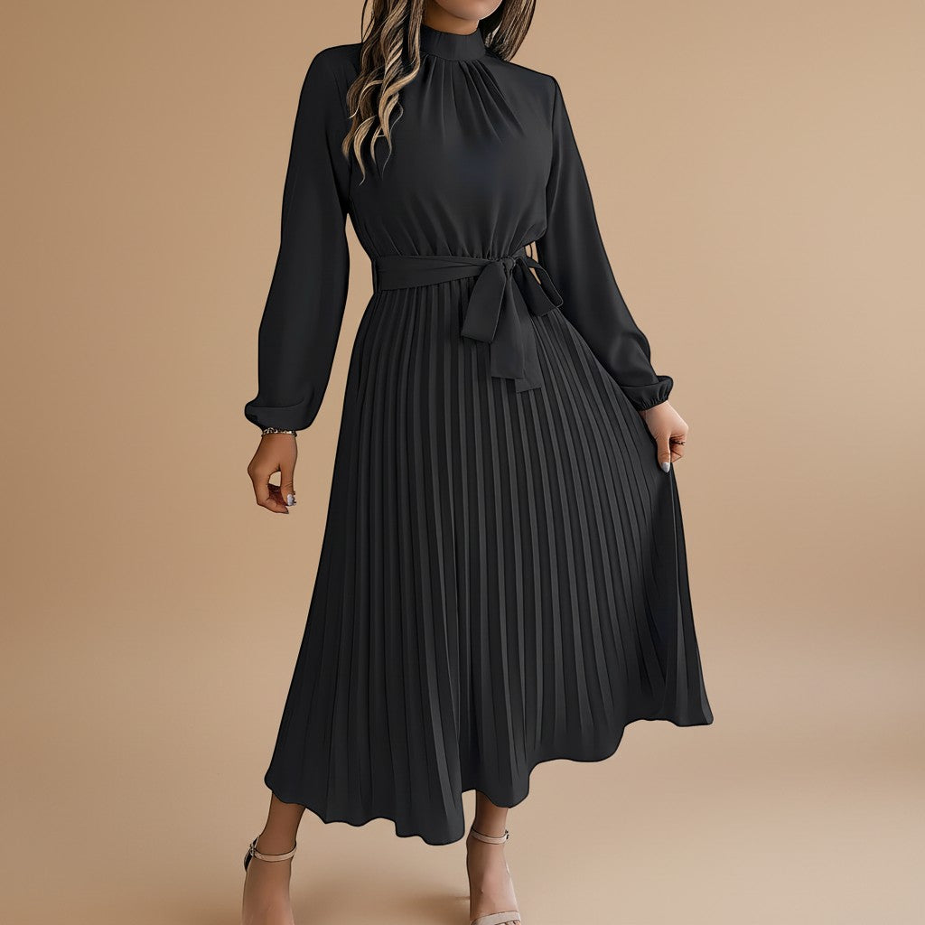 Yemelia black long sleeve pleated midi dress with high neck and waist tie. Elegant, flowing silhouette.