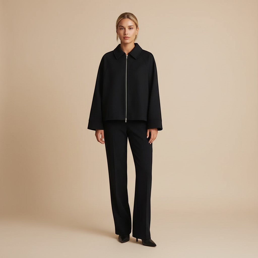 Yemelia black zip front jacket with classic collar and relaxed fit, made from structured fabric.