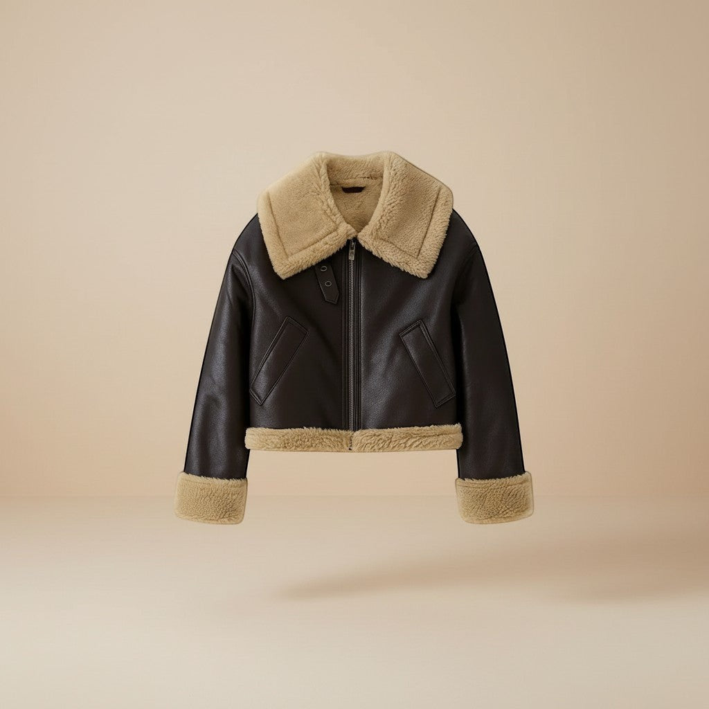 Yemelia dark brown faux leather jacket with cream shearling trim on collar, cuffs, and hem. Zip front closure.