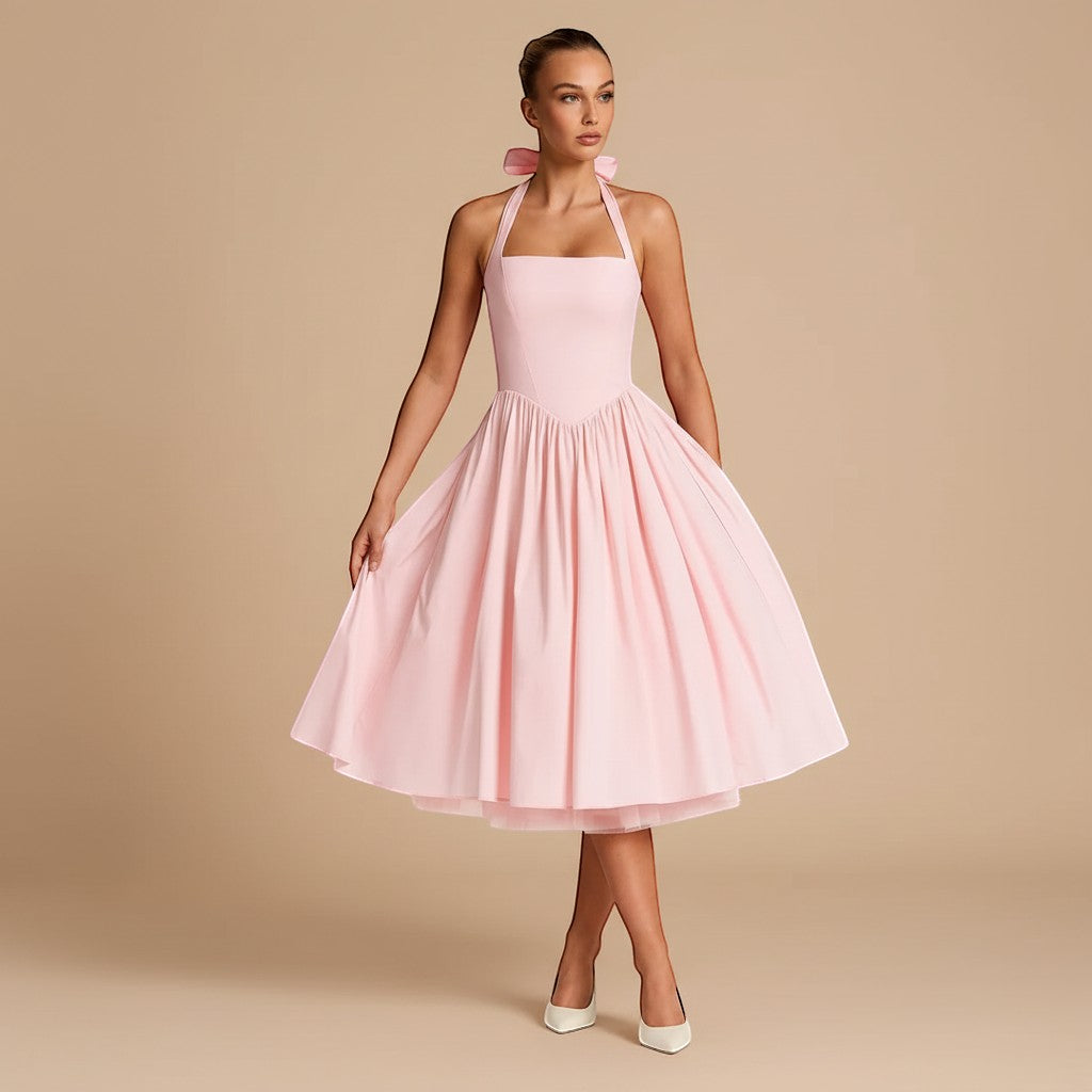 Yemelia light pink halter neck fit and flare midi dress with a full skirt and bow detail.