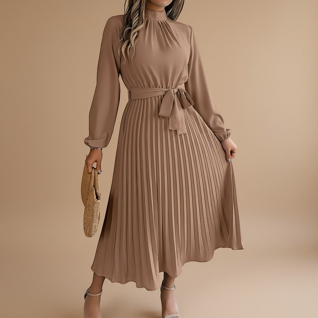 Yemelia taupe long sleeve pleated midi dress with high neck and waist tie. Elegant, flowing silhouette.