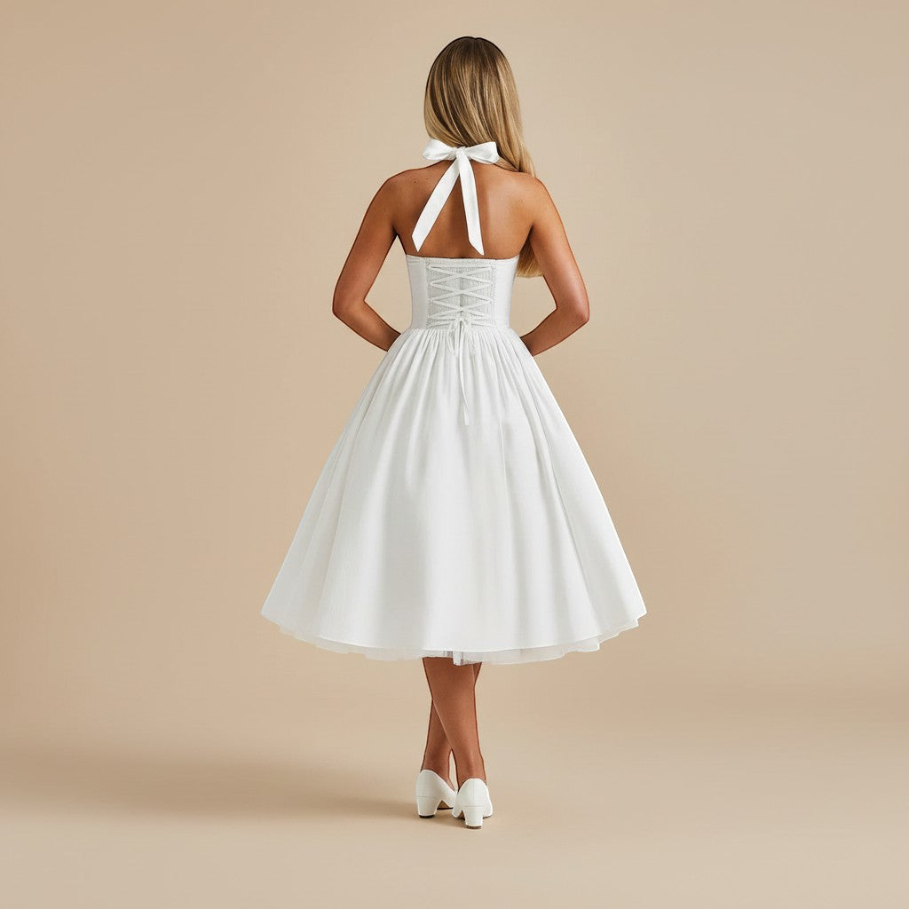 Yemelia white halter neck midi dress with corset back and flared skirt, perfect for formal occasions.